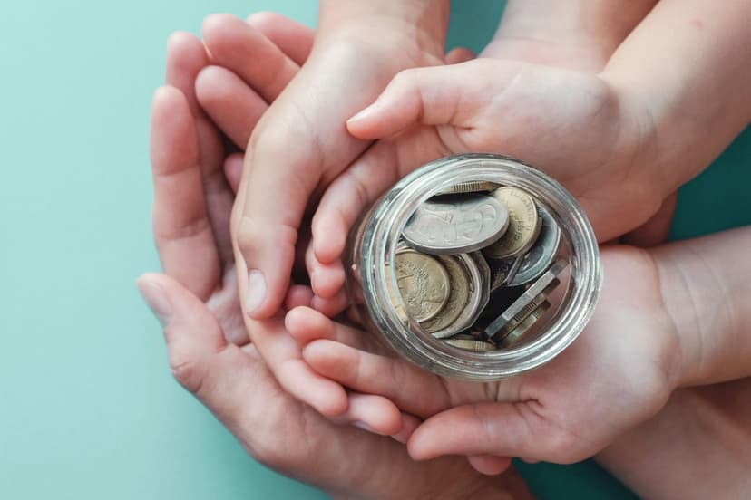 Hands holding jar with coins - Photo by Micheile Henderson on Unsplash